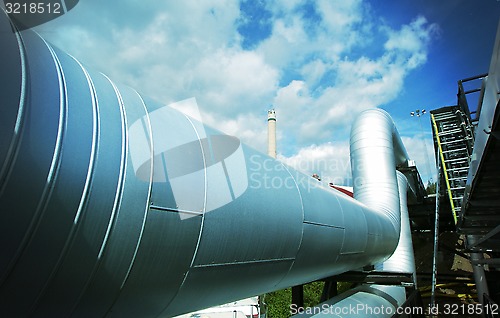 Image of Industrial zone, Steel pipelines and valves against blue sky