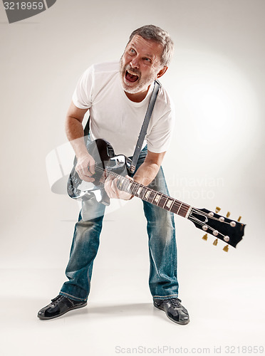 Image of Full length portrait of a guitar player 