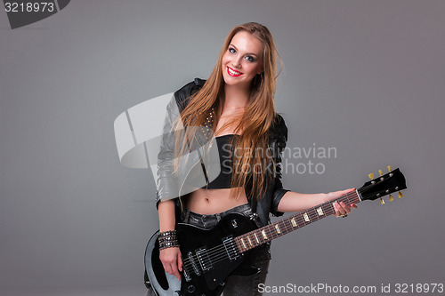 Image of Beautiful girl playing guitar