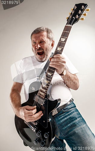 Image of portrait of a guitar player 