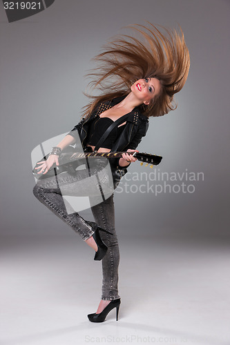 Image of Beautiful girl playing guitar