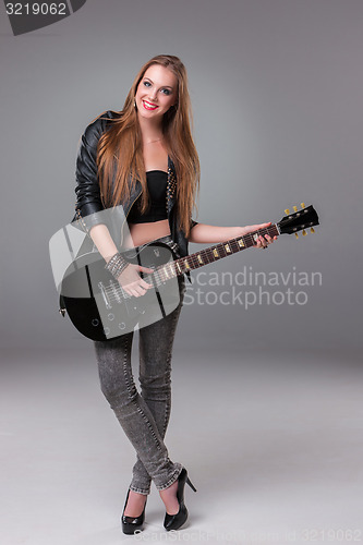 Image of Beautiful girl playing guitar