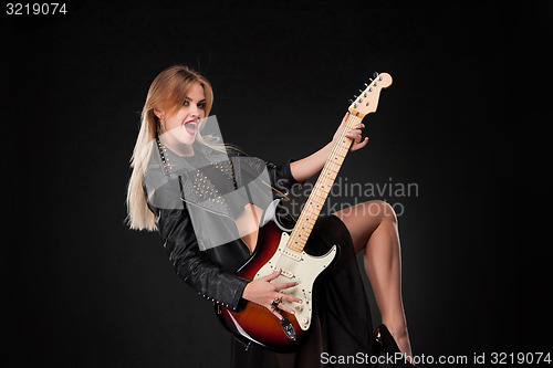 Image of Beautiful girl playing guitar