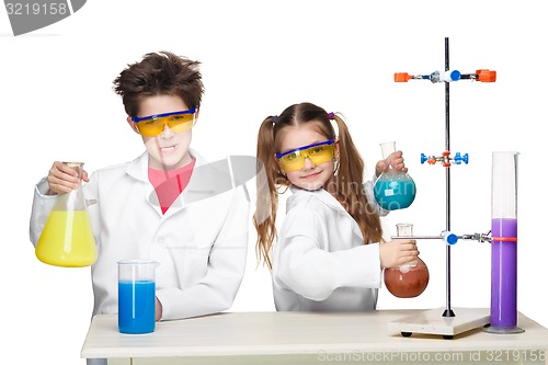 Image of Two cute children at chemistry lesson making experiments