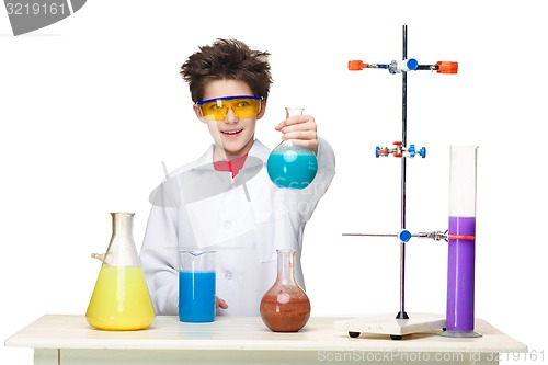 Image of Little boy as chemist doing experiment with chemical fluid in the laboratory