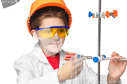 Image of Little boy as chemist doing experiment with chemical fluid in the laboratory