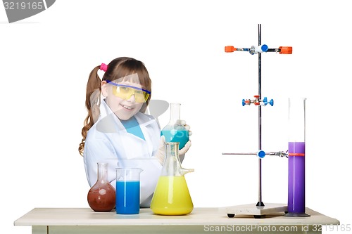 Image of Little girl as chemist doing experiment with chemical fluid in the laboratory