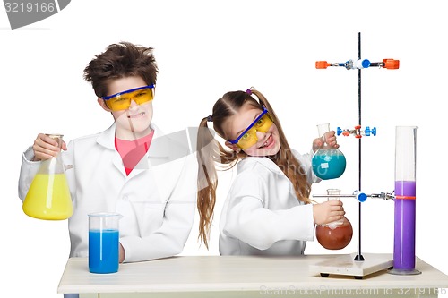 Image of Two cute children at chemistry lesson making experiments