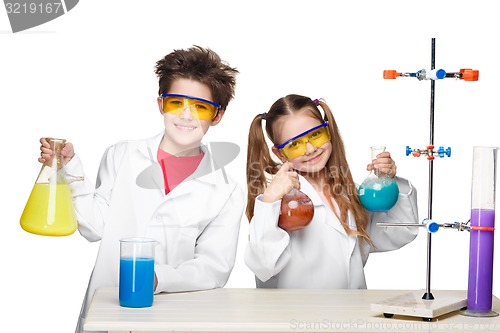 Image of Two cute children at chemistry lesson making experiments