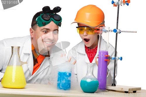 Image of Teen and teacher of chemistry at  lesson making experiments