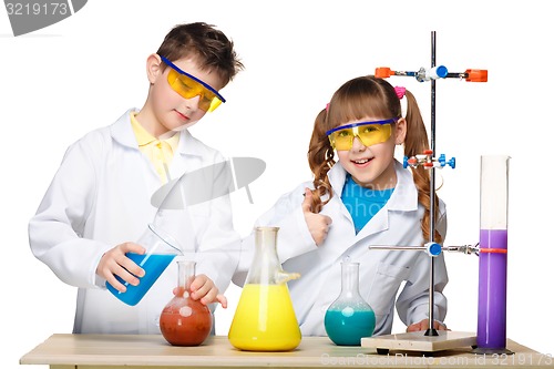 Image of Two cute children at chemistry lesson making experiments