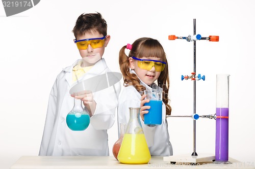 Image of Two cute children at chemistry lesson making experiments