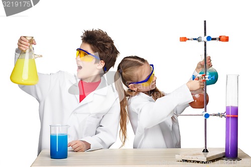 Image of Two cute children at chemistry lesson making experiments