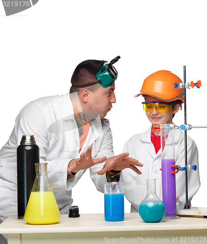 Image of Teen and teacher of chemistry at  lesson making experiments