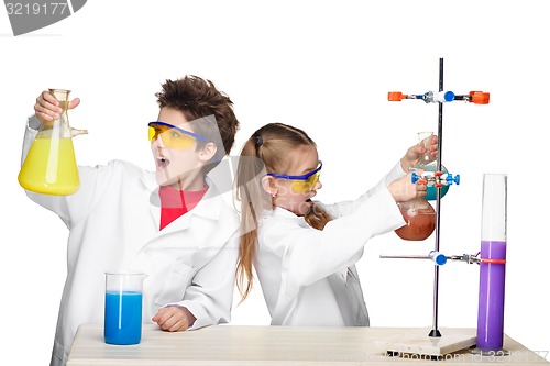 Image of Two cute children at chemistry lesson making experiments