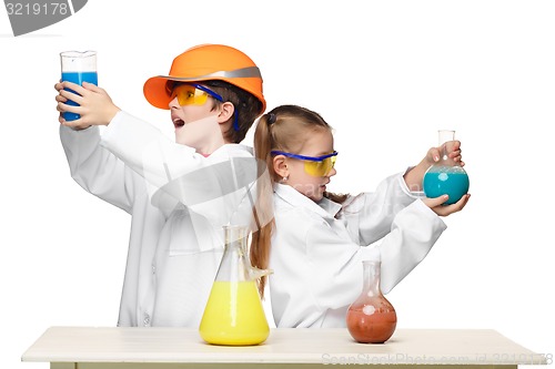 Image of Two cute children at chemistry lesson making experiments