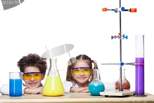 Image of Two cute children at chemistry lesson making experiments