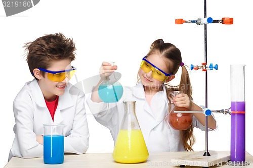 Image of Two cute children at chemistry lesson making experiments