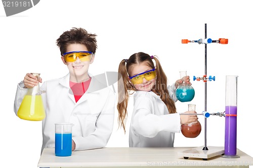 Image of Two cute children at chemistry lesson making experiments