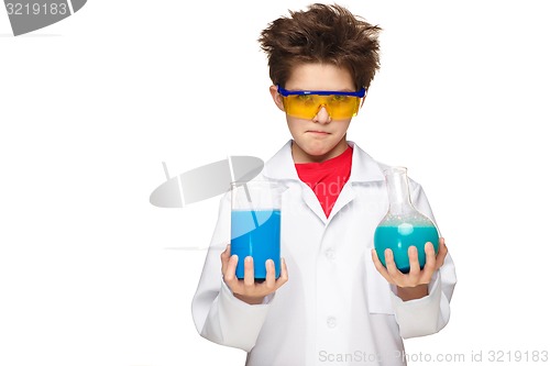 Image of Little boy as chemist doing experiment with chemical fluid in the laboratory