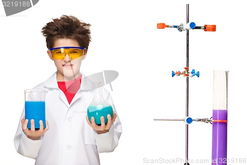 Image of Little boy as chemist doing experiment with chemical fluid in the laboratory