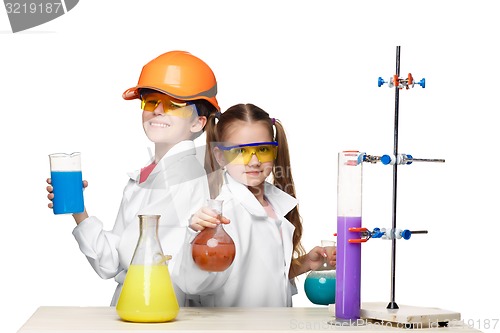 Image of Two cute children at chemistry lesson making experiments