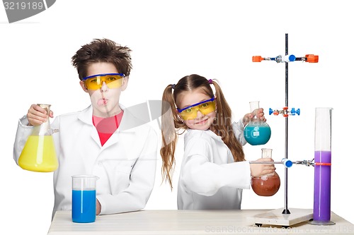 Image of Two cute children at chemistry lesson making experiments