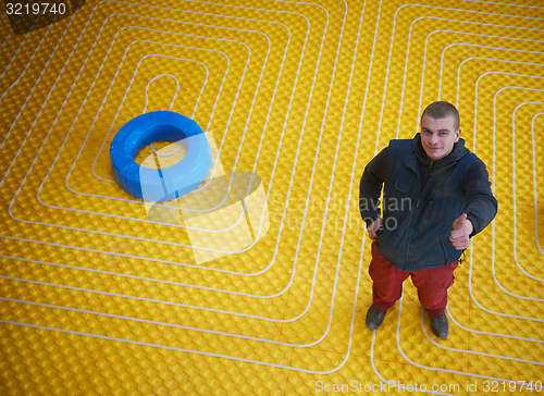 Image of workers installing underfloor heating system