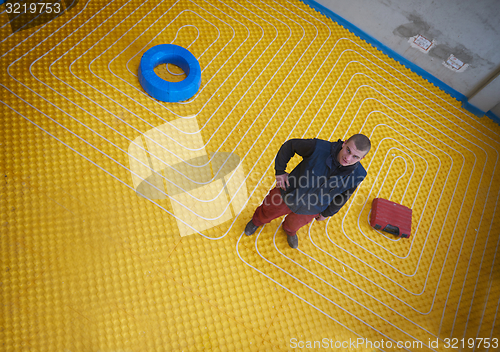 Image of workers installing underfloor heating system