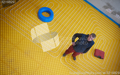 Image of workers installing underfloor heating system