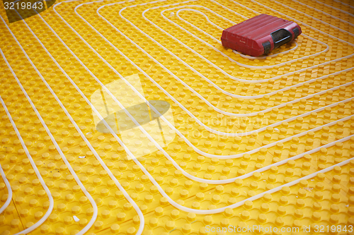 Image of workers installing underfloor heating system