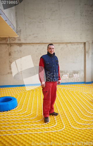 Image of workers installing underfloor heating system