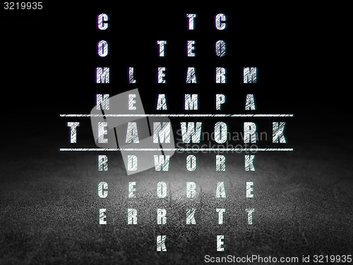 Image of Finance concept: word Teamwork in solving Crossword Puzzle