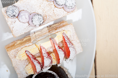 Image of selection of fresh cream cake dessert plate 