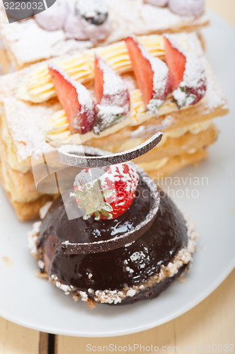 Image of selection of fresh cream cake dessert plate 