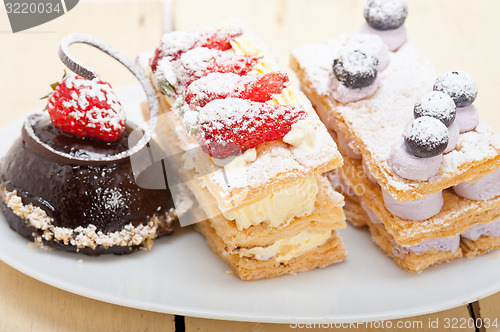 Image of selection of fresh cream cake dessert plate 