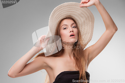 Image of Beautiful girl with hat posing in studio