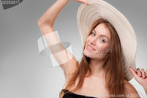 Image of Beautiful girl with hat posing in studio