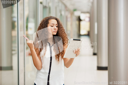 Image of Beautiful young girl paying by credit card for shopping 