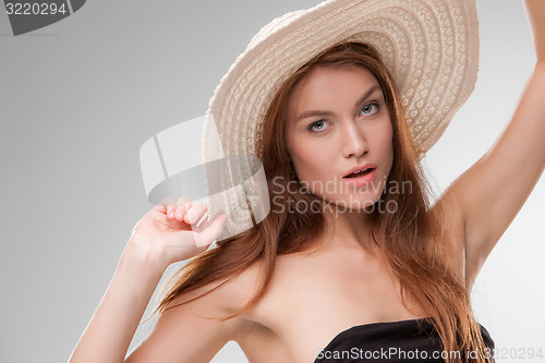 Image of Beautiful girl with hat posing in studio