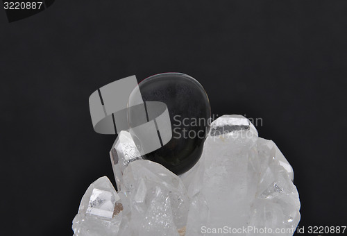 Image of Obsidian on rock crystal