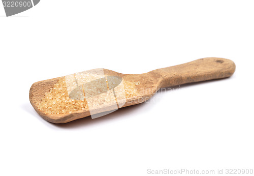 Image of Brown cane sugar on shovel