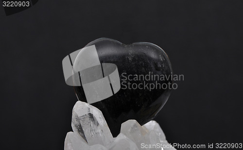 Image of Obsidian on rock crystal