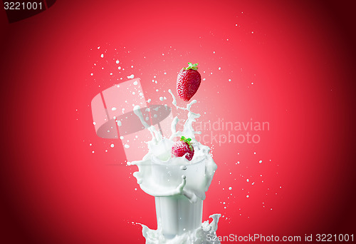 Image of Strawberries falls in milk 