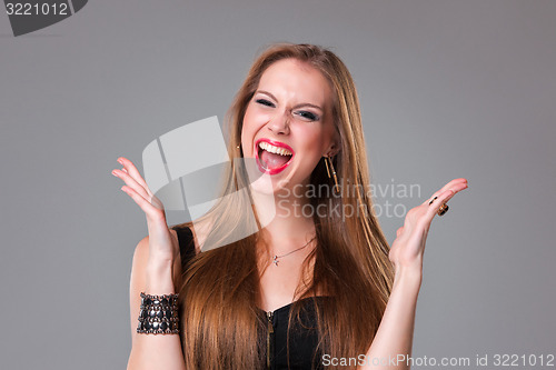 Image of Portrait of happy brunette girl looking at camera