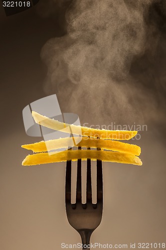 Image of French fries on a fork