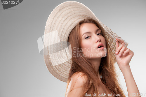 Image of Beautiful girl with hat posing in studio