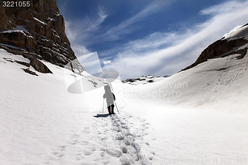 Image of Silhouette of hiker on snow plateau