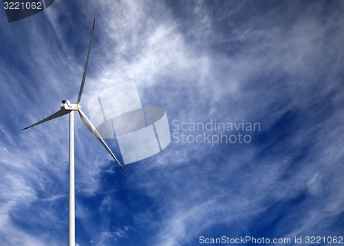 Image of Wind turbine and blue sky with clouds