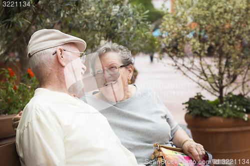 Image of Senior Couple on Bench in the Market Place